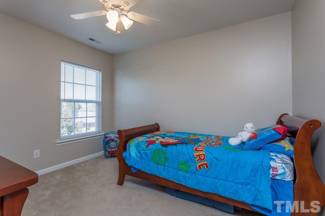 3709 Marshlane Way Raleigh, NC 27610 - Photo 7 of 9 a bedroom with a bed and a window