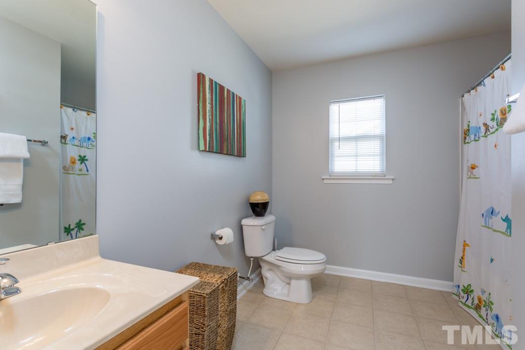 3709 Marshlane Way Raleigh, NC 27610 - Photo 8 of 9 a bathroom with a sink toilet and window