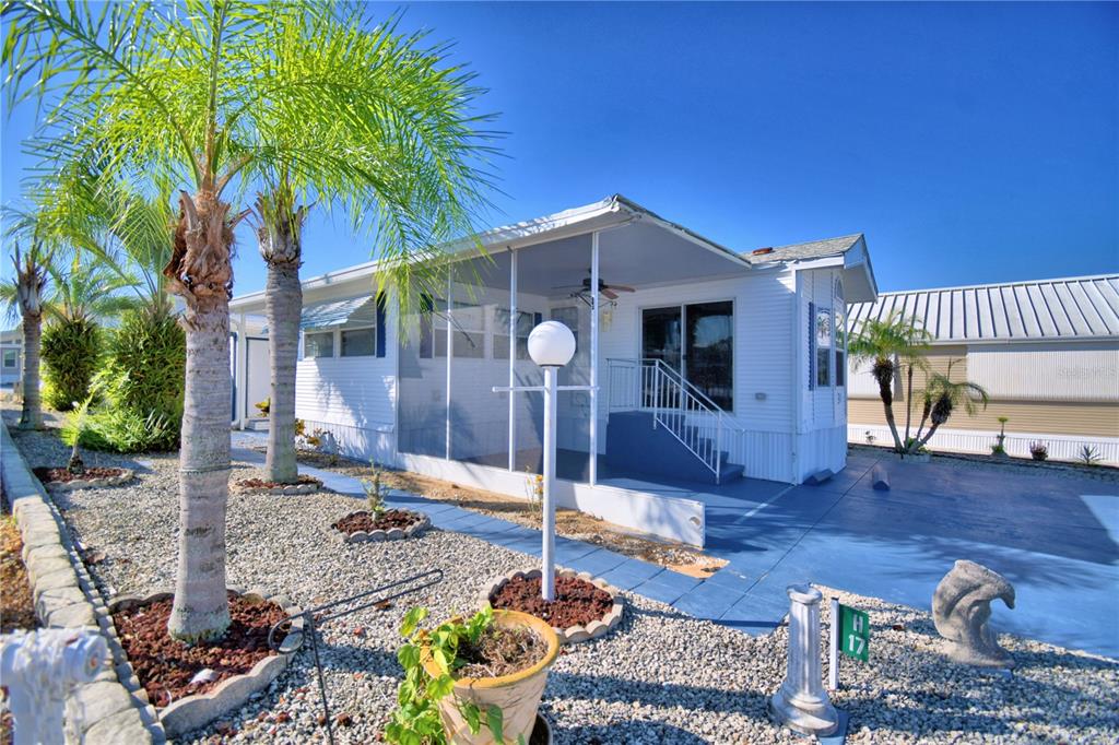 251 Patterson Road, Unit H17 Haines City, FL 33844 - Photo 1 of 47 a front view of a house with garden