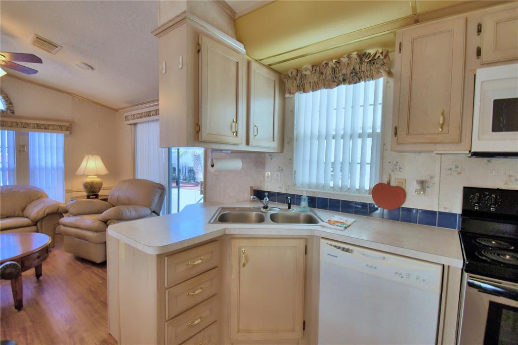 251 Patterson Road, Unit H17 Haines City, FL 33844 - Photo 17 of 47 a kitchen with a sink cabinets and window