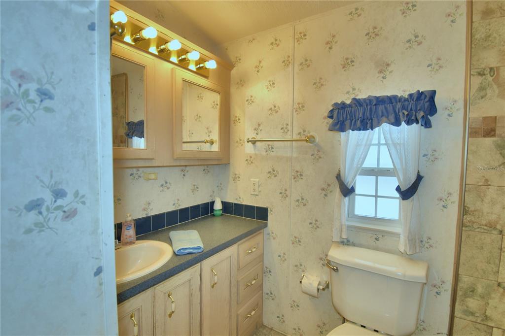 251 Patterson Road, Unit H17 Haines City, FL 33844 - Photo 20 of 47 a bathroom with a granite countertop sink toilet and shower