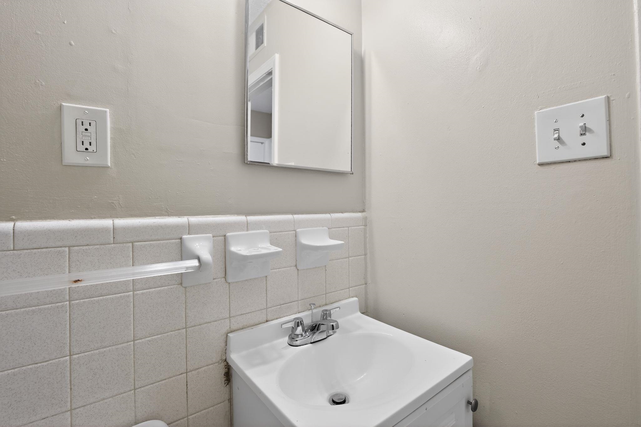 3637 Neely Road Memphis, TN 38109 - Photo 22 of 30 a bathroom with a sink and a mirror