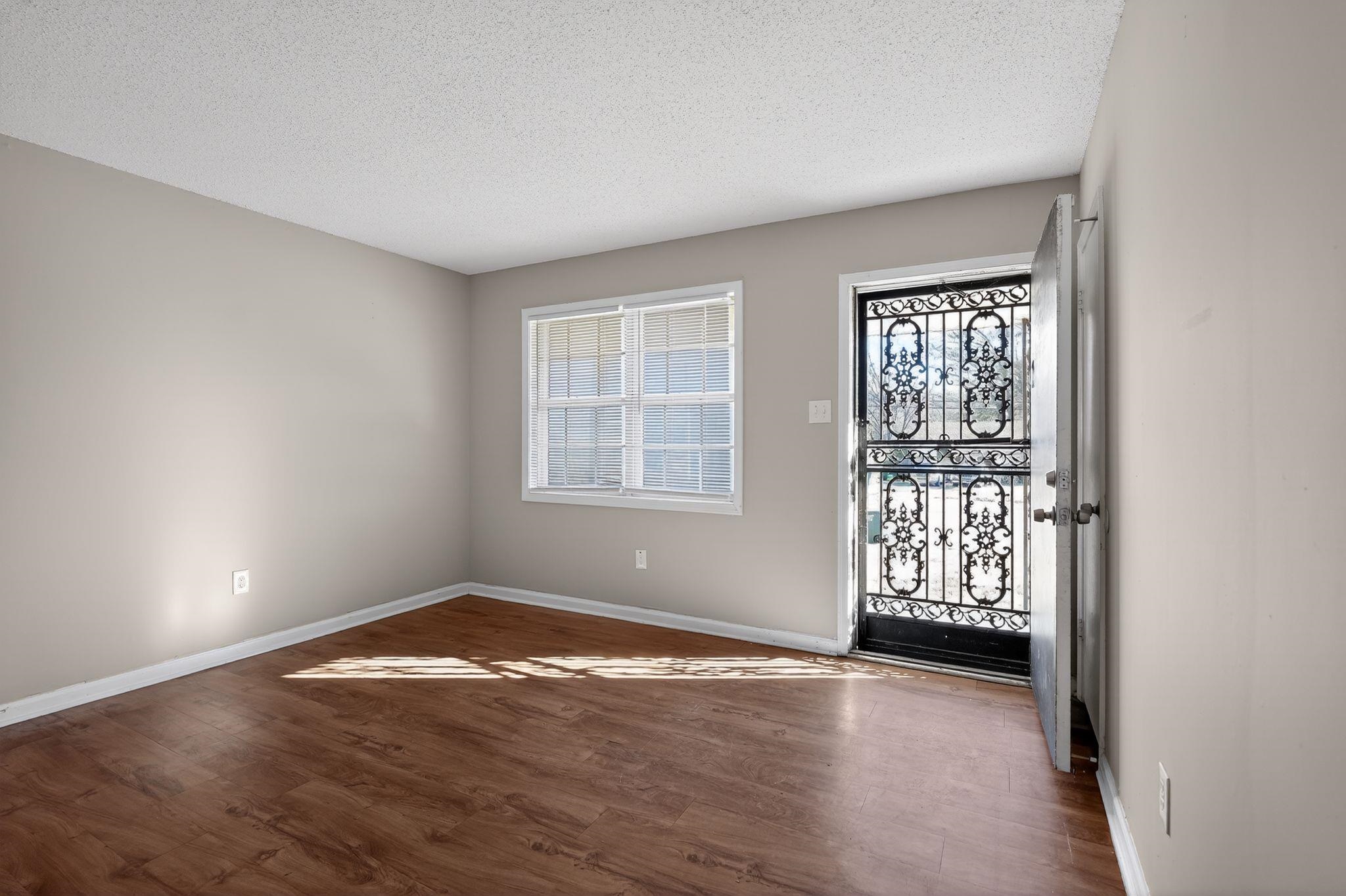 3637 Neely Road Memphis, TN 38109 - Photo 6 of 30 an empty room with wooden floor and windows