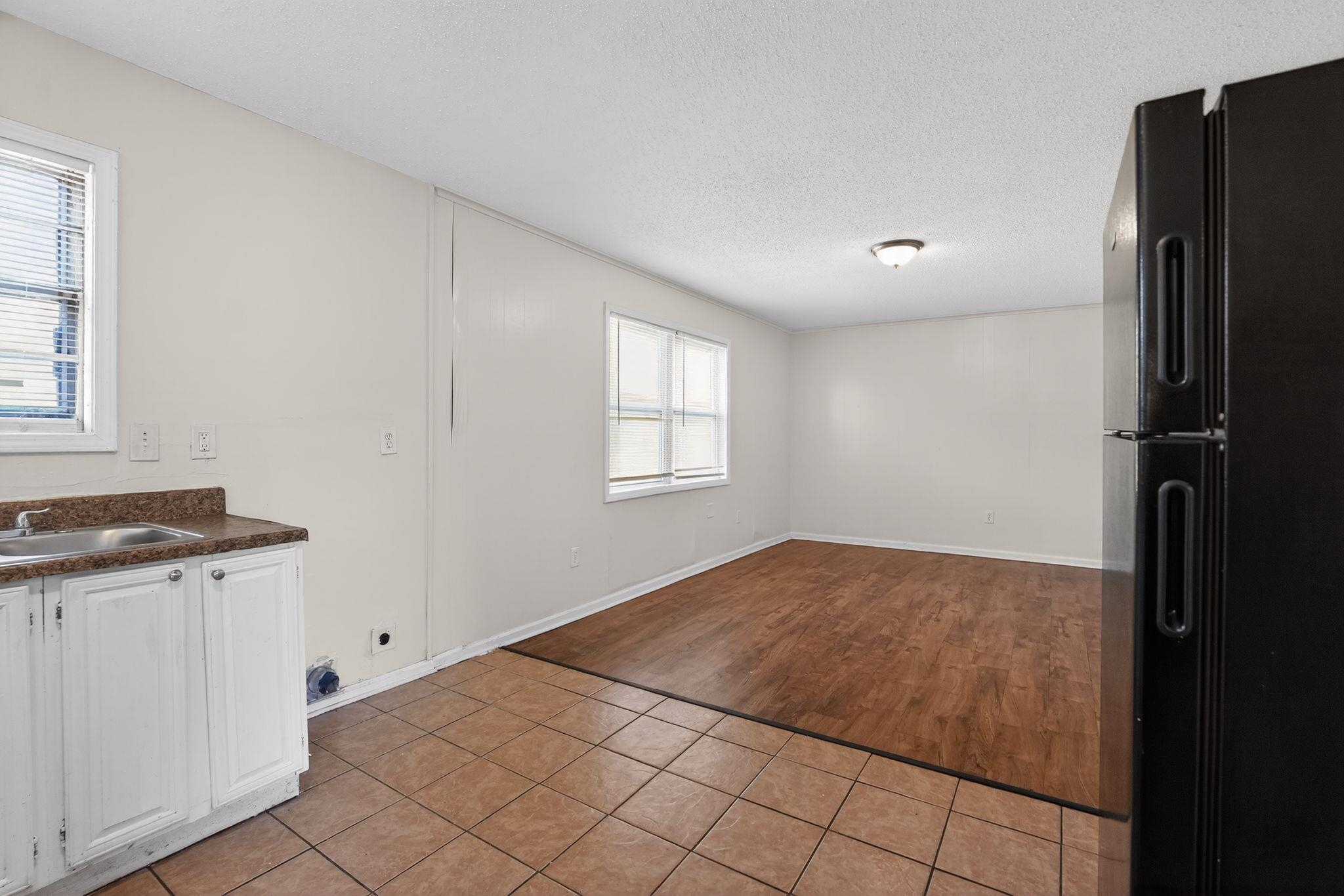 3637 Neely Road Memphis, TN 38109 - Photo 9 of 30 a view of a kitchen with a sink and a refrigerator