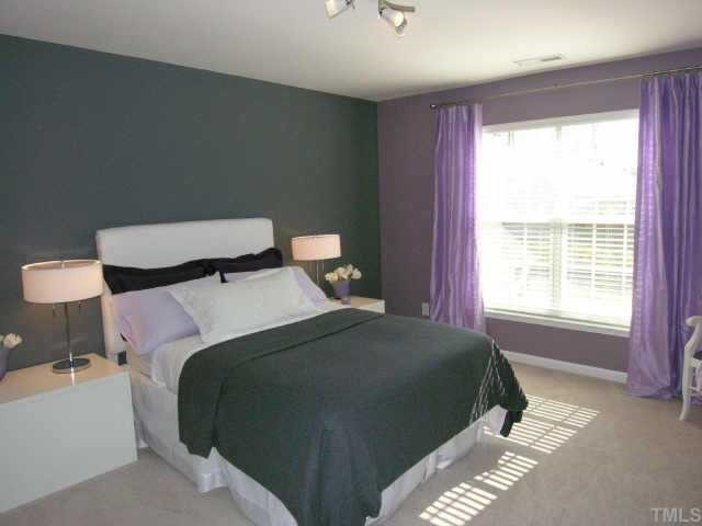 5506 Kirner Court Raleigh, NC 27613 - Photo 7 of 9 a bedroom with a bed and a lamp