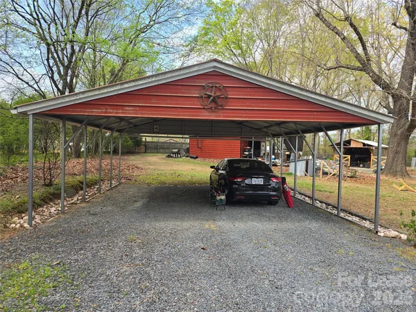 a view of a house with a cars parked in a road