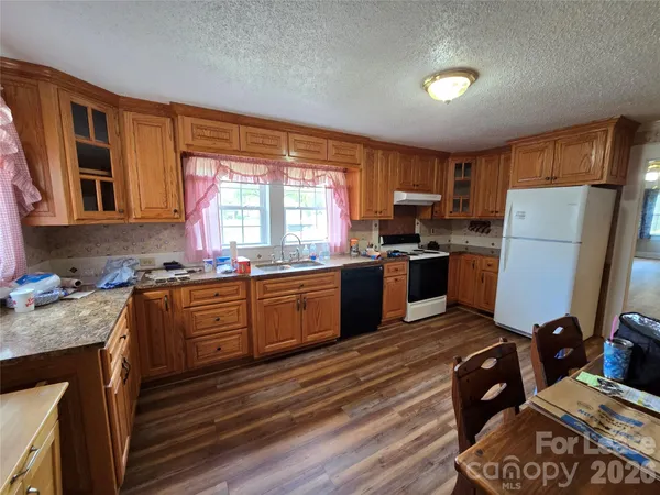 a kitchen with wooden floors and a appliances