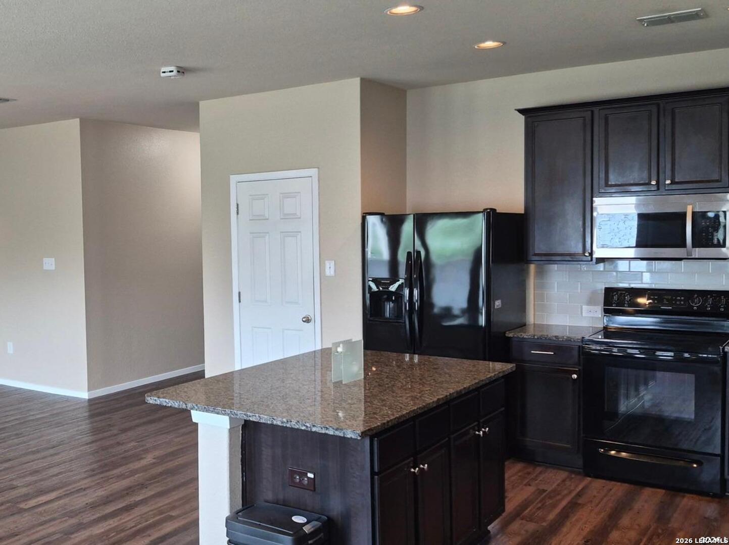 7102 Zuma Beach Converse, TX 78109 - Photo 8 of 31 a kitchen with granite countertop a stove a sink and a refrigerator