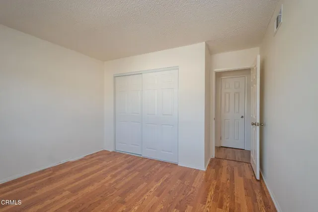 a bathroom with a sink a toilet a mirror and shower curtain