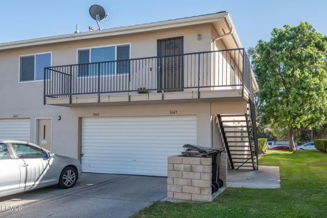 a swimming pool with outdoor seating and trees