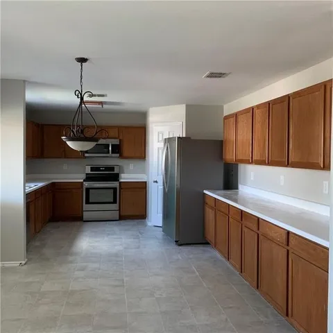a kitchen with stainless steel appliances a refrigerator and a sink