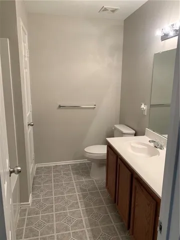 a bathroom with a sink a toilet and a mirror