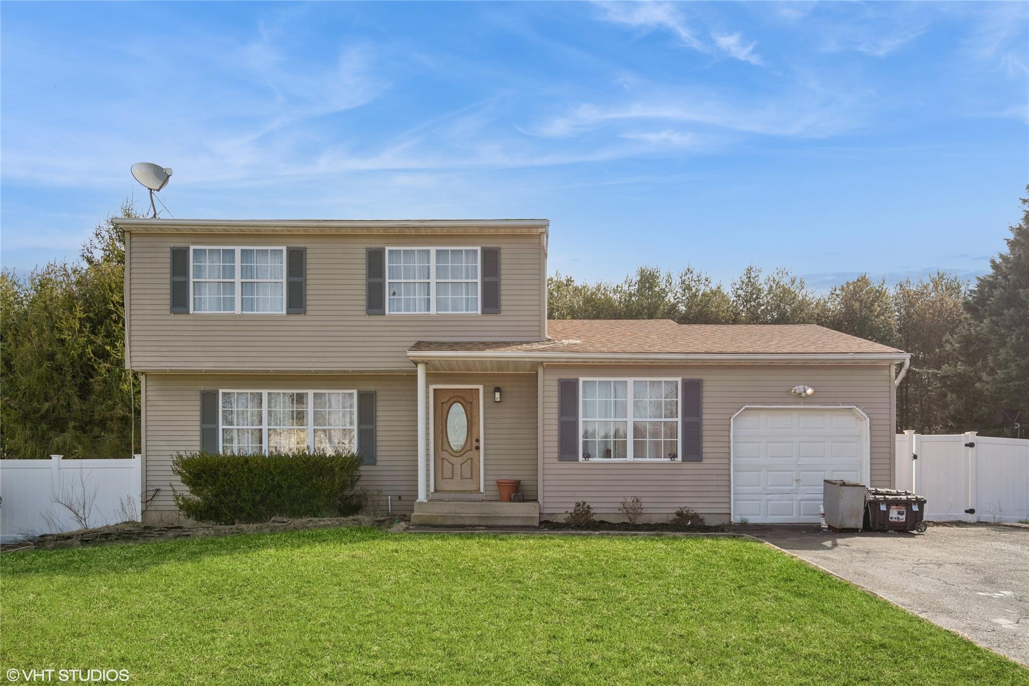 33 Sundown Drive Bellport, NY 11713 - Photo 1 of 1 View of front of home featuring aphalt driveway, fence, a gate, and a front yard