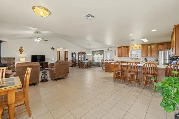 a living room with lots of furniture and a dining table