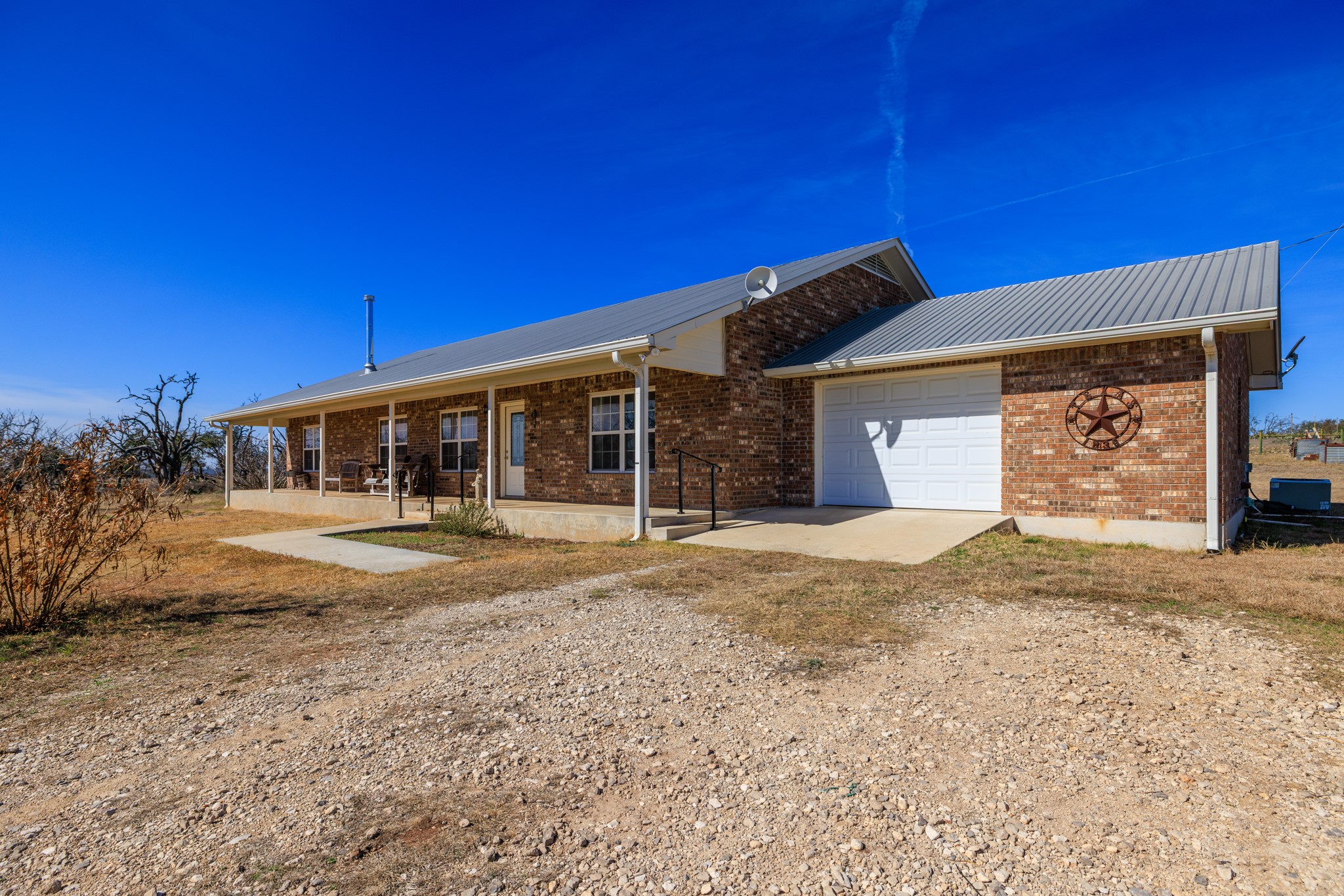 2020 Wendel Road Harper, TX 78631 - Photo 2 of 40 a front view of a house with a yard and garage