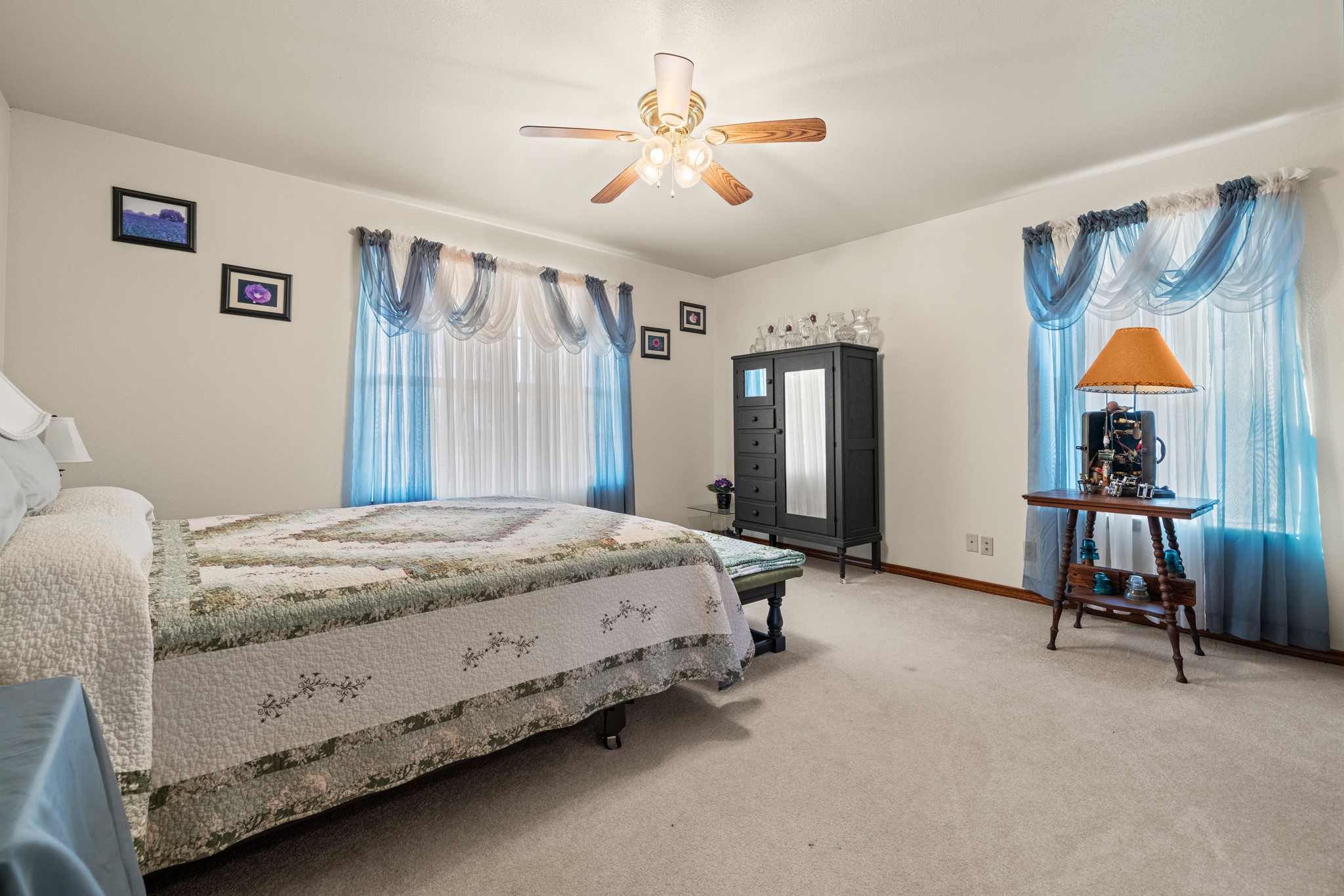 2020 Wendel Road Harper, TX 78631 - Photo 22 of 40 a spacious bedroom with a bed and a chandelier