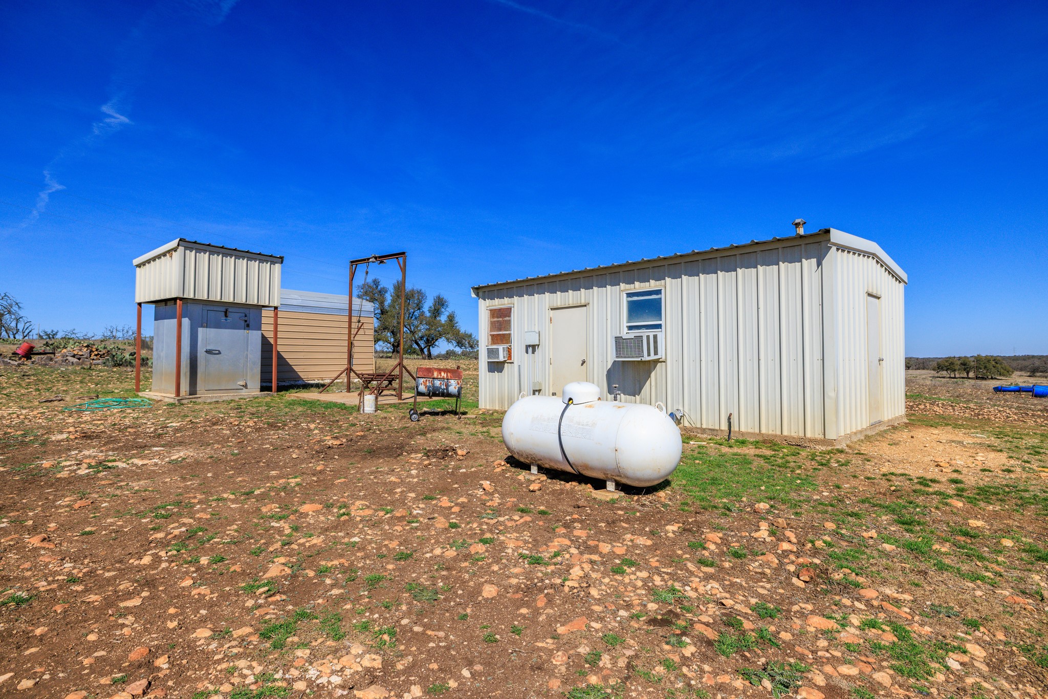 2020 Wendel Road Harper, TX 78631 - Photo 23 of 40 a view of a wooden floor and a fire pit in middle of the patio