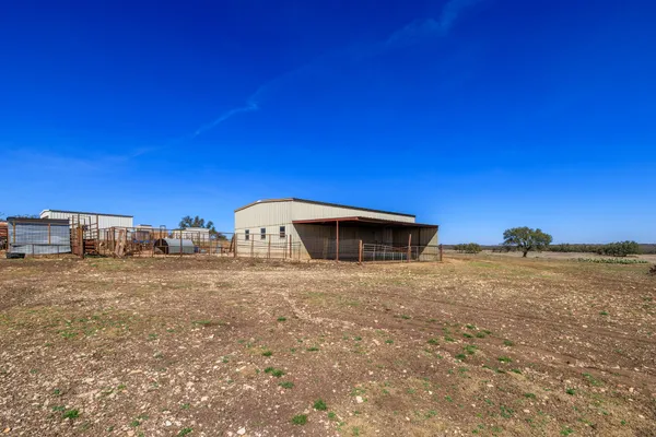 a view of a dry yard with a house
