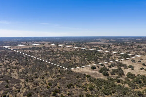 an aerial view of house with yard