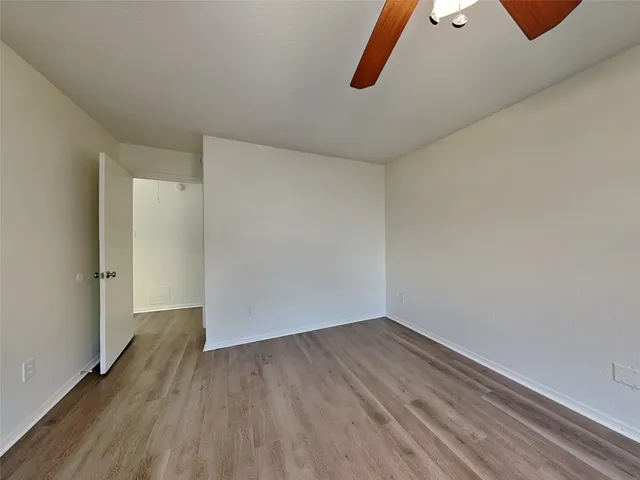 a view of a room with wooden floor