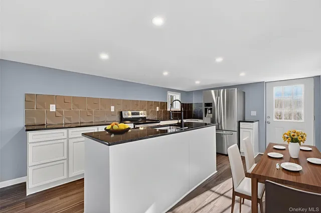 a kitchen with stainless steel appliances a stove a sink and a refrigerator