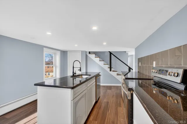 a kitchen with sink refrigerator and stove