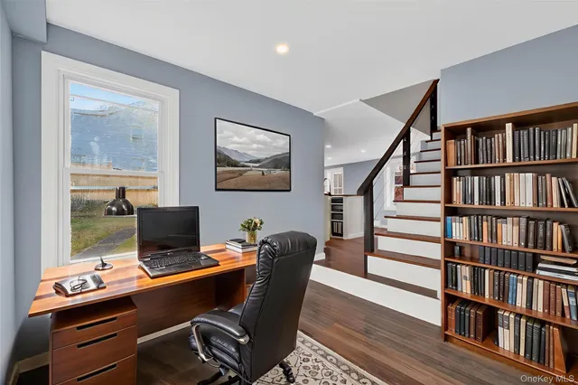 a view of a workspace with furniture and a bookshelf