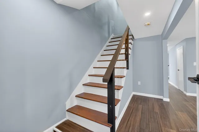a view of entryway with wooden floor and stairs