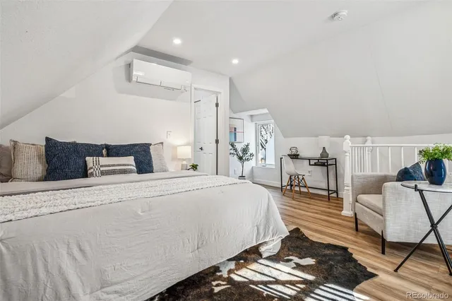 a bedroom with bed and chair