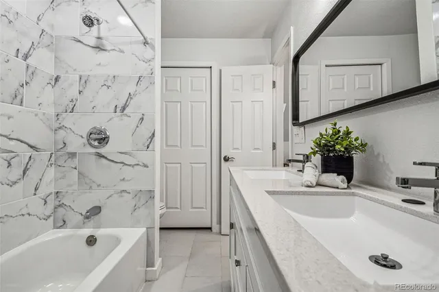 a bathroom with a sink a bathtub and a mirror