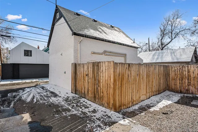 a view of a house with a wooden fence