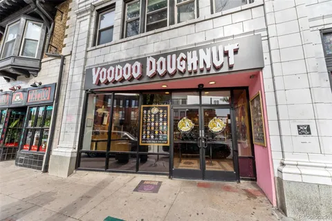 a view of a cafe with a couple of people