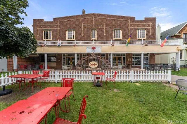 a front view of a house with a yard table and chairs
