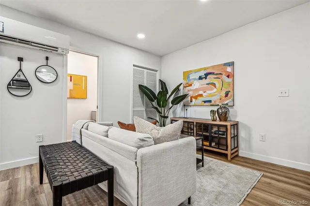 a living room with furniture and wall paintings