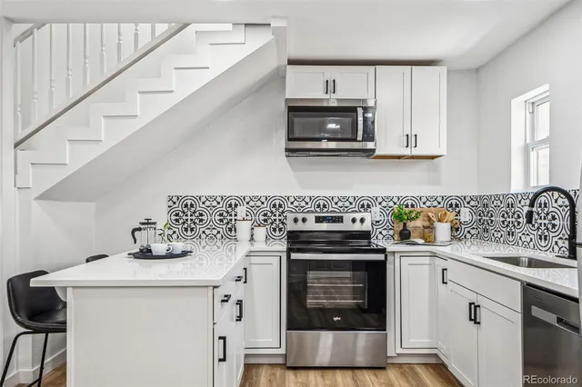 a kitchen with cabinets and appliances