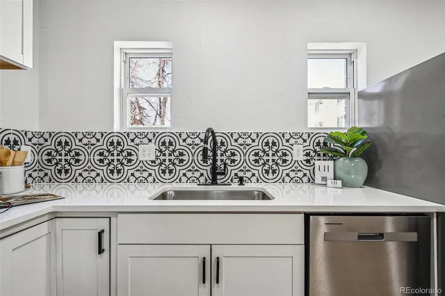 a view of a kitchen sink dishwasher with wooden floor