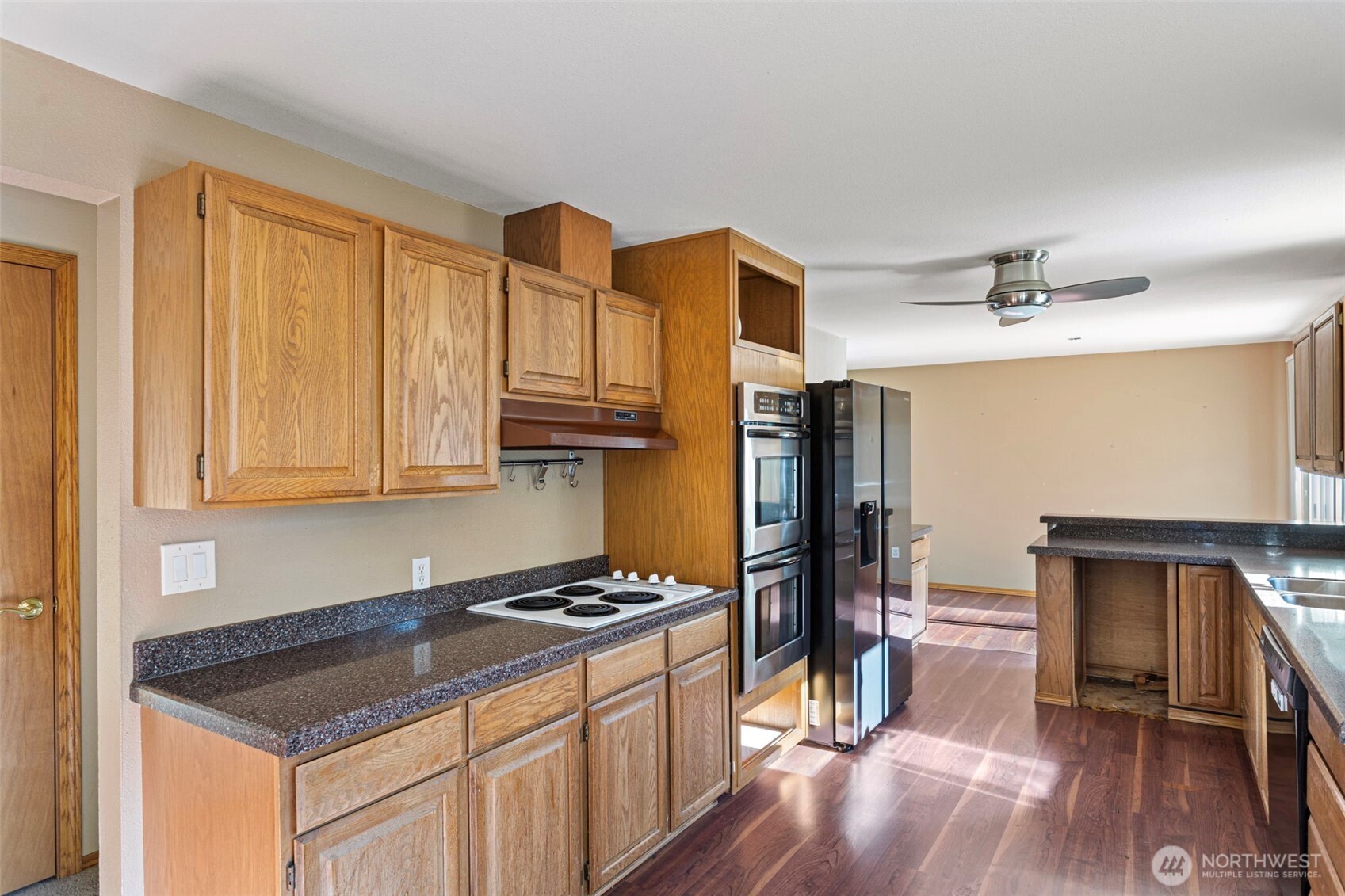23829 Southeast 208th Street Maple Valley, WA 98038 - Photo 11 of 32 a kitchen with stainless steel appliances granite countertop a stove refrigerator and cabinets