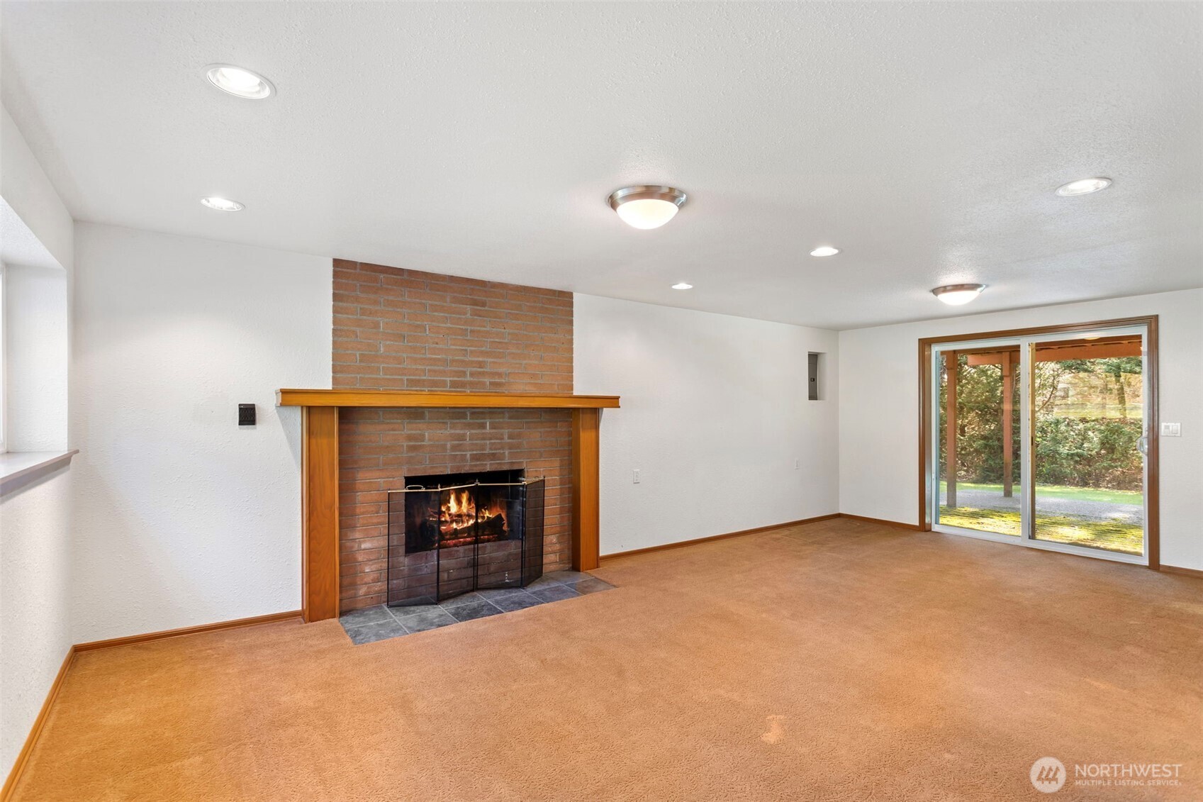 23829 Southeast 208th Street Maple Valley, WA 98038 - Photo 20 of 32 a view of an empty room with a fireplace and a window