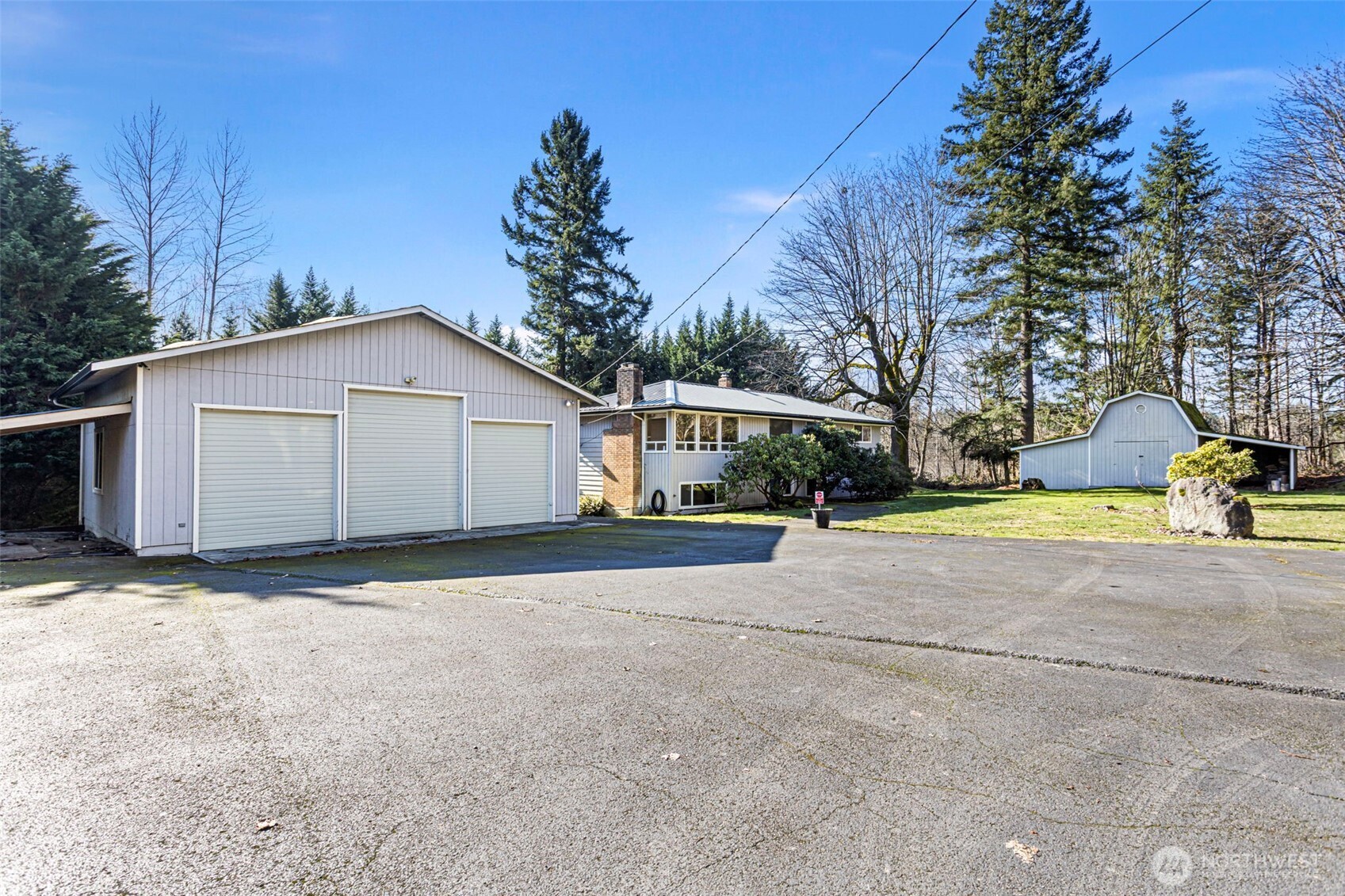 23829 Southeast 208th Street Maple Valley, WA 98038 - Photo 2 of 32 a view of a house with backyard and trees