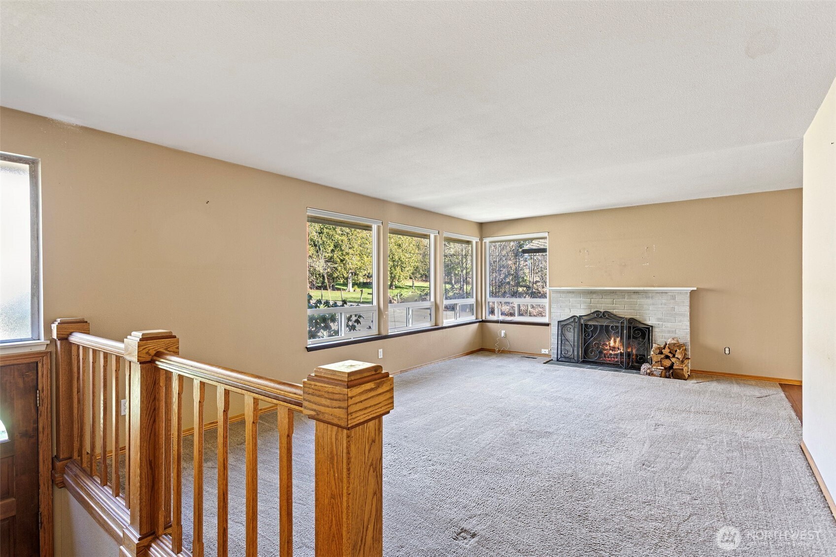 23829 Southeast 208th Street Maple Valley, WA 98038 - Photo 5 of 32 a view of an empty room with a fireplace and a window