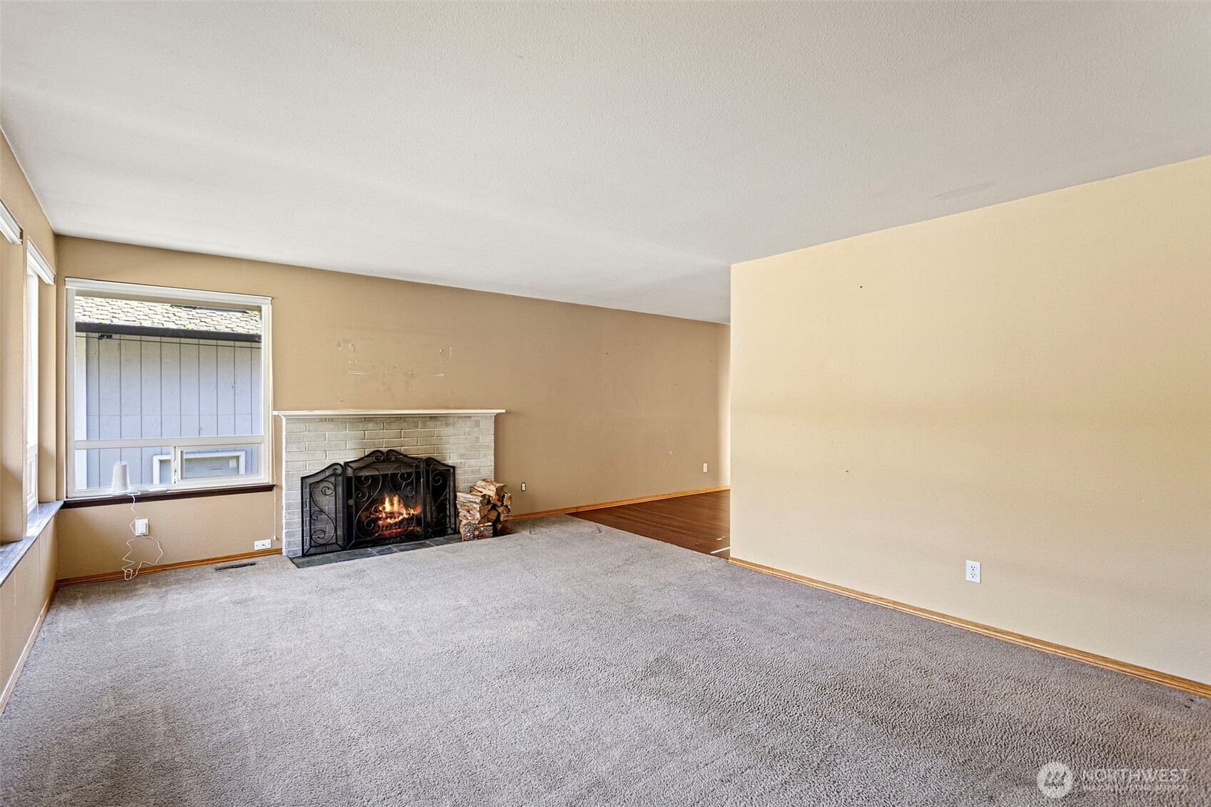 23829 Southeast 208th Street Maple Valley, WA 98038 - Photo 7 of 32 a view of an empty room with a fireplace and a window