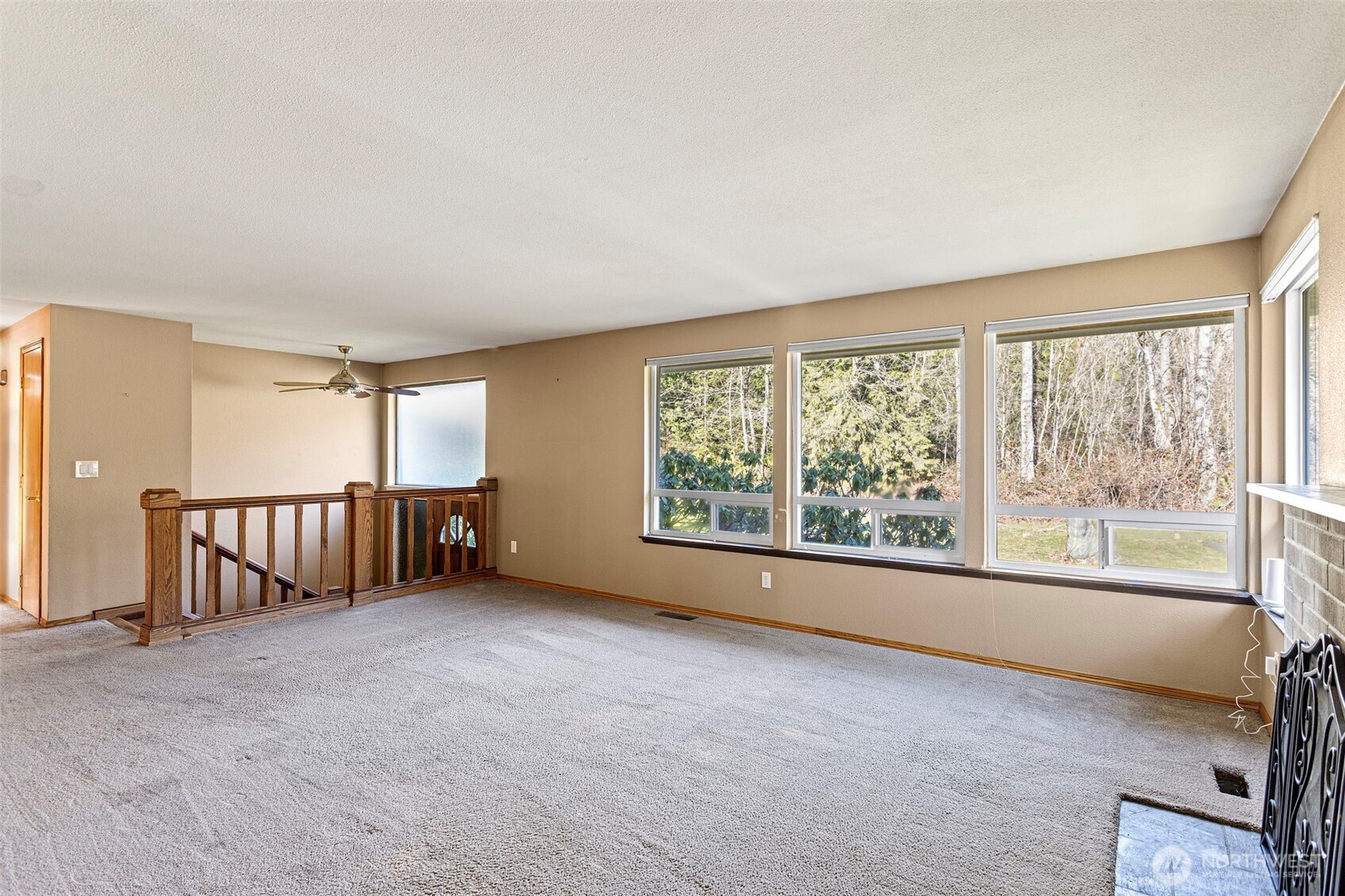 23829 Southeast 208th Street Maple Valley, WA 98038 - Photo 8 of 32 an empty room with windows and mountain view
