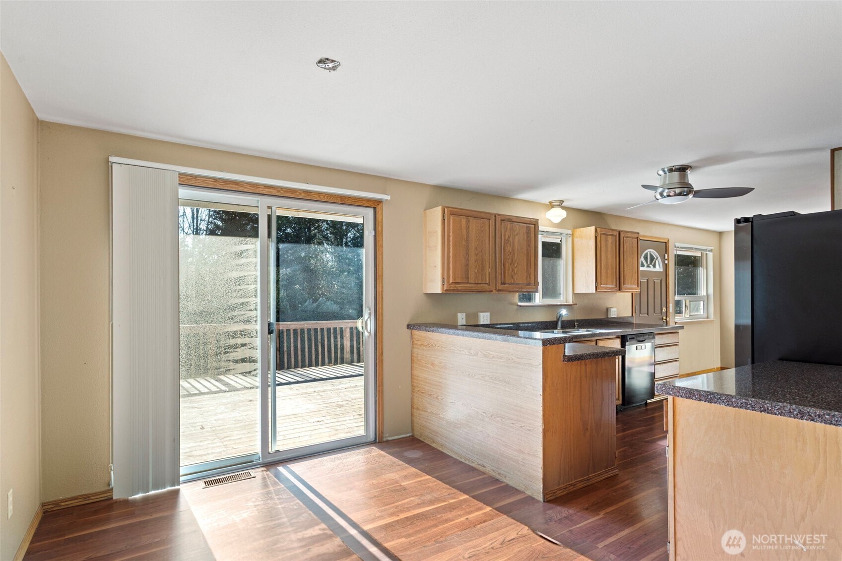23829 Southeast 208th Street Maple Valley, WA 98038 - Photo 9 of 32 a kitchen with stainless steel appliances granite countertop a refrigerator oven a sink with wooden cabinets and wooden floor