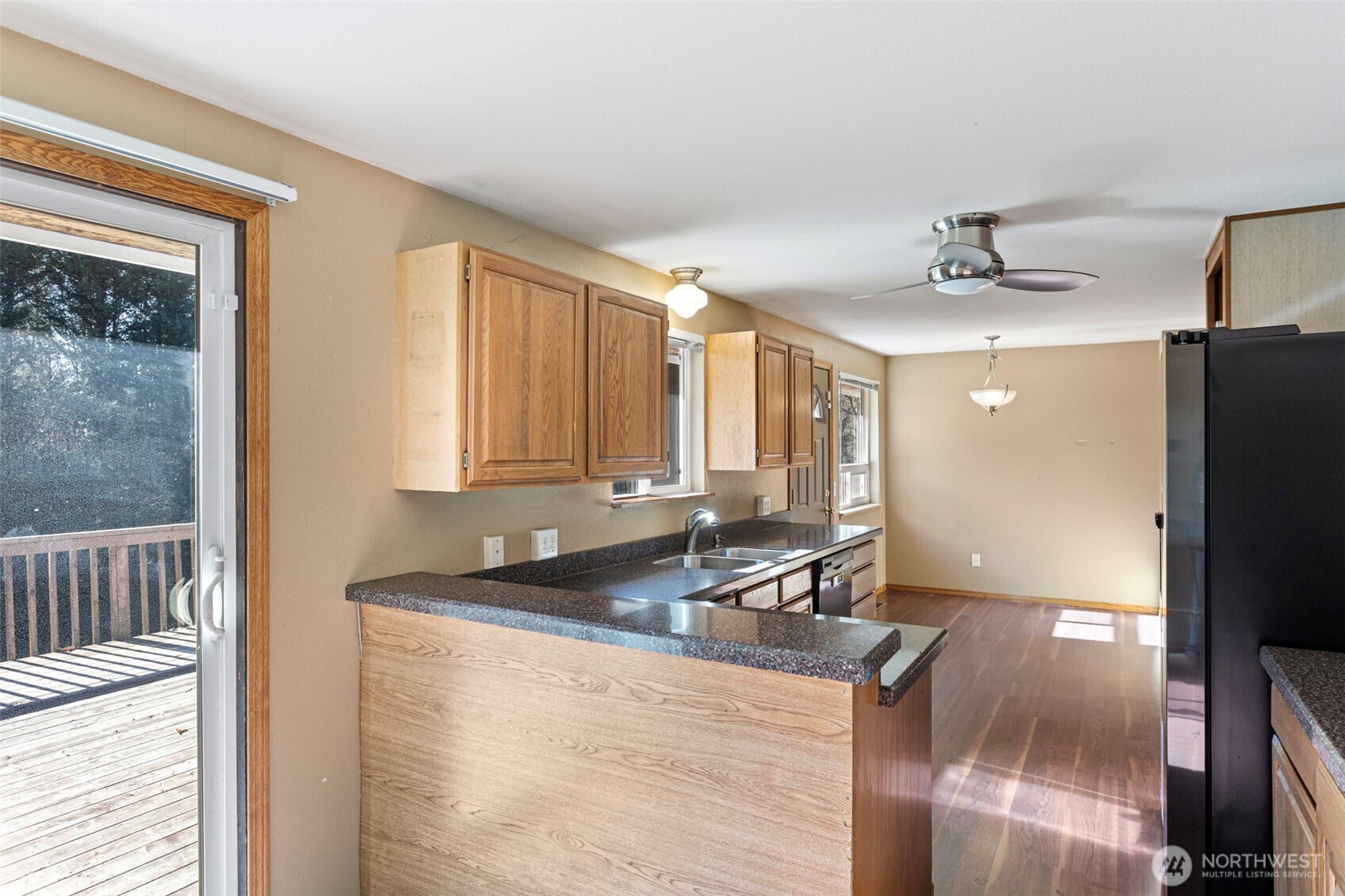 23829 Southeast 208th Street Maple Valley, WA 98038 - Photo 10 of 32 a kitchen with granite countertop a sink a counter top space and cabinets