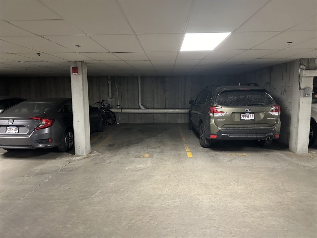 318 Rindge Avenue, Unit 216 Cambridge, MA 02140 - Photo 15 of 15 a view of garage with a car parked in it