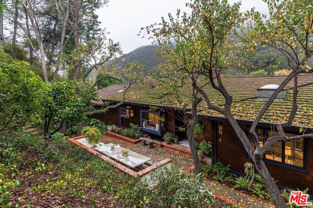 3266 Mandeville Canyon Road Los Angeles, CA 90049 - Photo 1 of 37 an aerial view of a house with swimming pool and trees