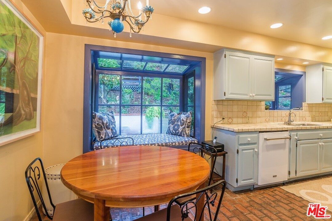 3266 Mandeville Canyon Road Los Angeles, CA 90049 - Photo 12 of 37 a view of a dining room with furniture window and outside view