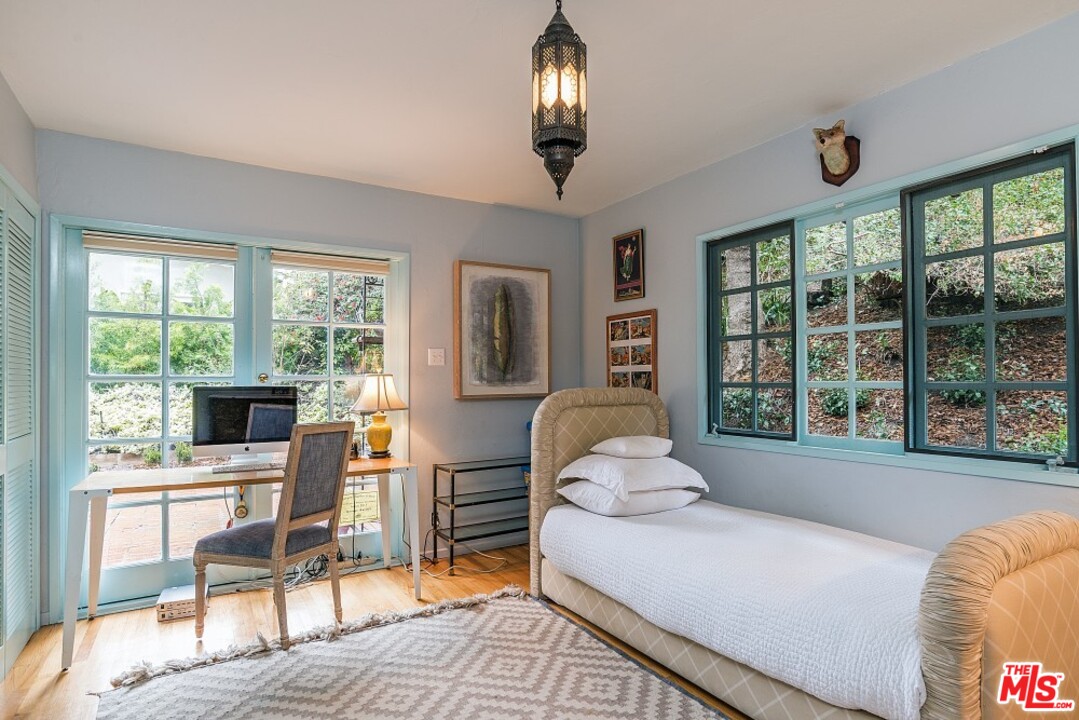 3266 Mandeville Canyon Road Los Angeles, CA 90049 - Photo 18 of 37 a living room with furniture and large windows