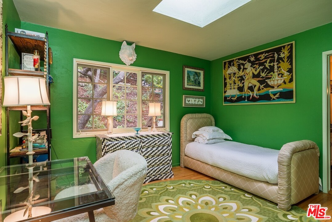 3266 Mandeville Canyon Road Los Angeles, CA 90049 - Photo 19 of 37 a bedroom with furniture and a window