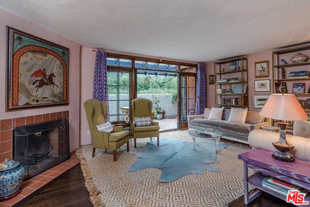 3266 Mandeville Canyon Road Los Angeles, CA 90049 - Photo 3 of 37 a living room with furniture a rug and a fireplace